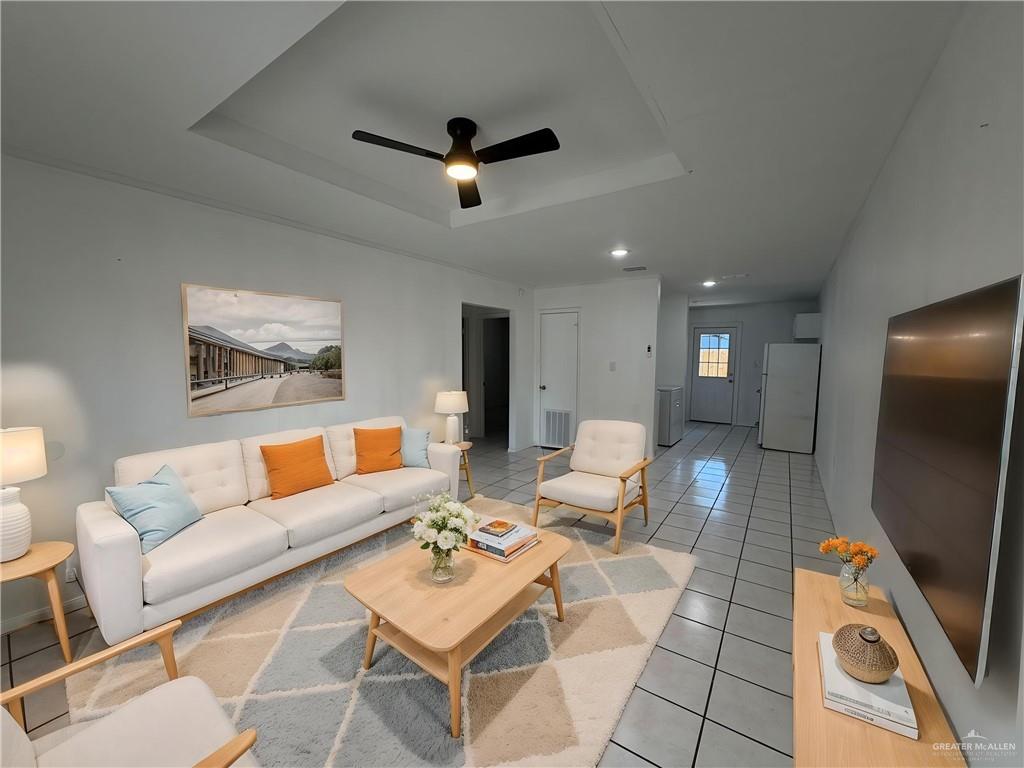 2612 West Mile 17 1/2 Road, Unit 12 Edinburg, TX 78541 - Photo 6 of 10 Living area featuring a tray ceiling with a ceiling fan, recessed lighting, and tile flooring-Virtualy Staged