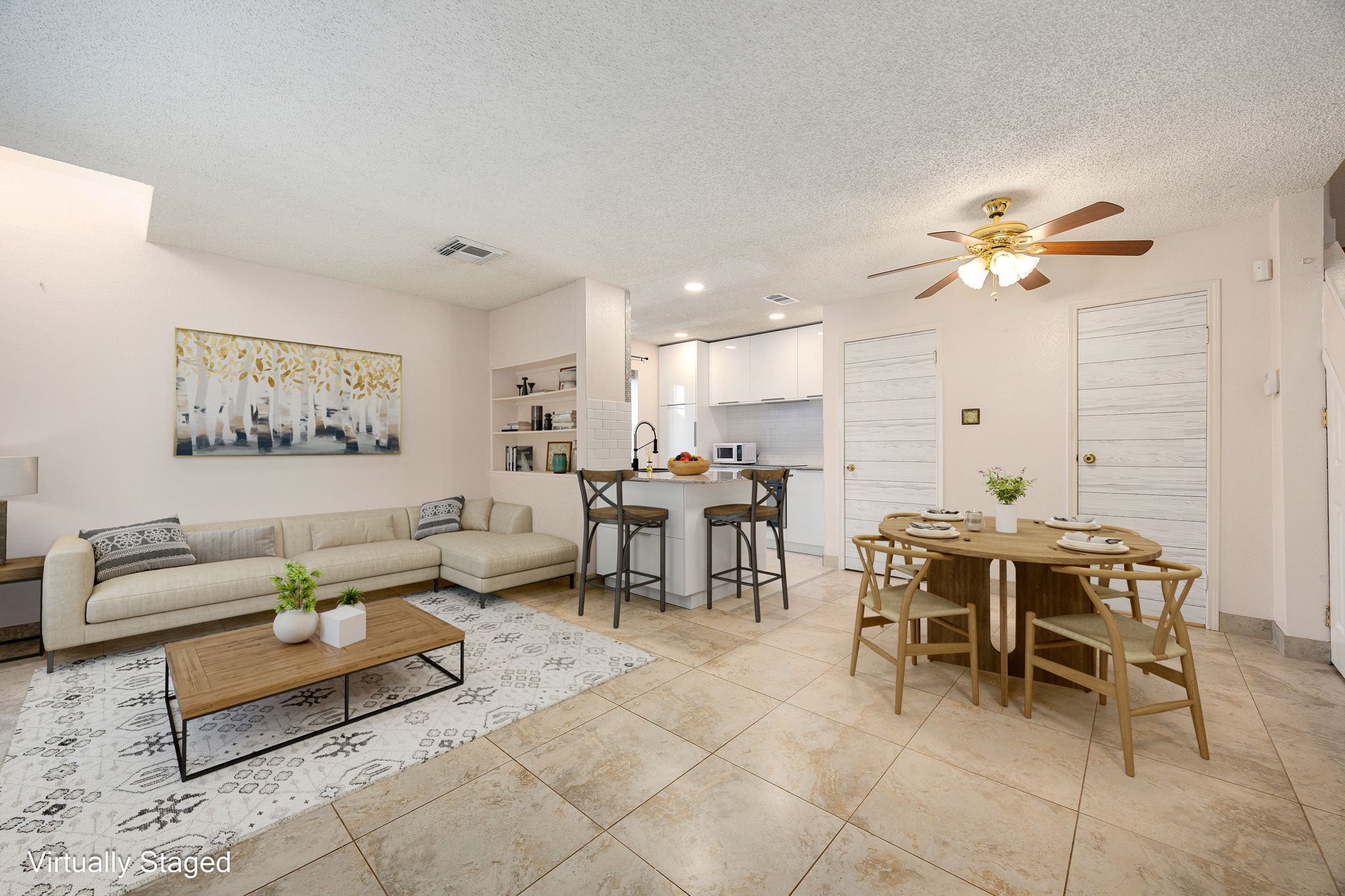 a living room with furniture a chandelier and a dining table