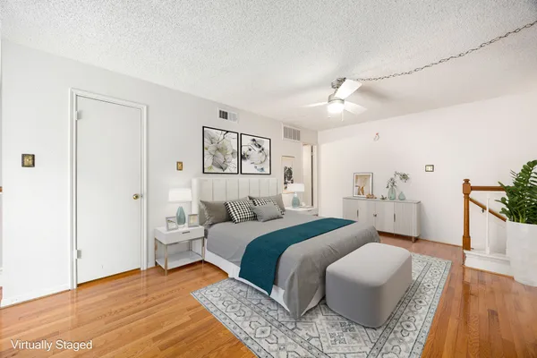 a bedroom with a bed and a potted plant