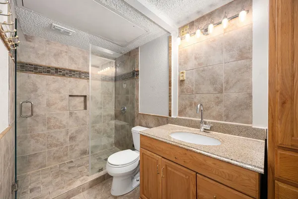 a bathroom with a sink toilet and shower