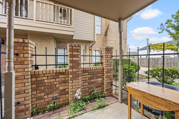 a view of a balcony with chairs and potted plants