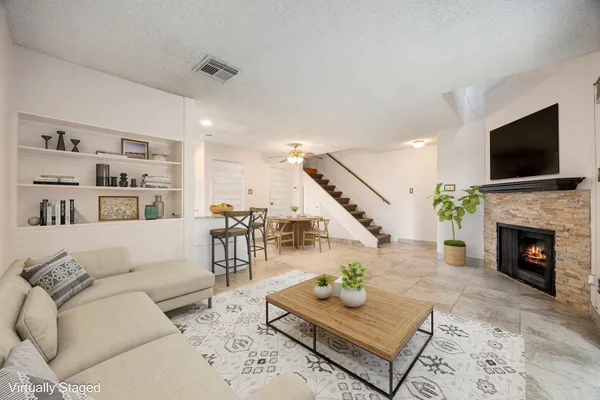 a living room with furniture and a fireplace
