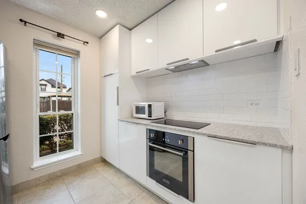 a kitchen with stainless steel appliances granite countertop a sink and a stove