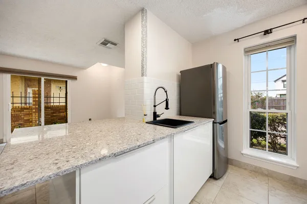 a kitchen with stainless steel appliances granite countertop a sink and a granite counter tops