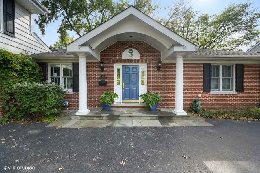 915 Golfview Road Glenview, IL 60025 - Photo 1 of 31 a front view of a house with a yard and garage