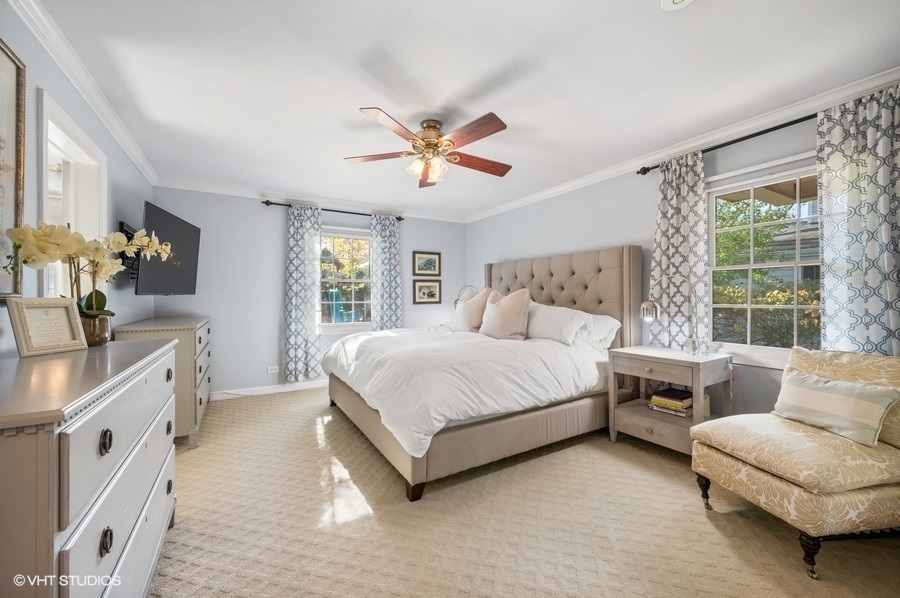 915 Golfview Road Glenview, IL 60025 - Photo 13 of 31 a spacious bedroom with a bed and a couch