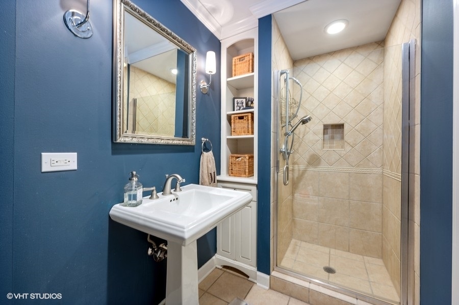 915 Golfview Road Glenview, IL 60025 - Photo 17 of 31 a bathroom with a sink and a mirror
