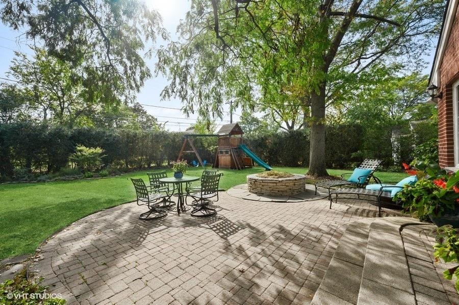 915 Golfview Road Glenview, IL 60025 - Photo 26 of 31 a view of a patio with a table chairs and a yard