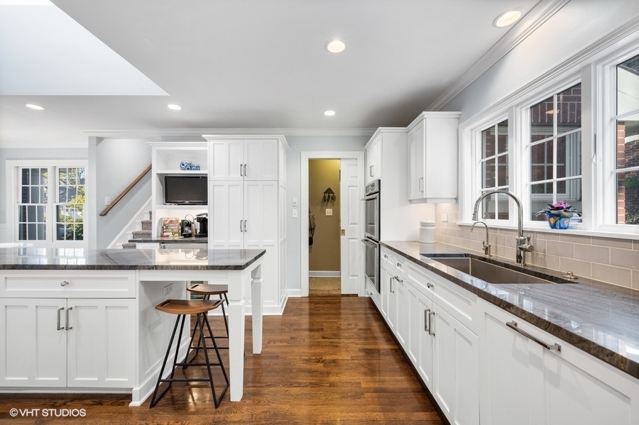 915 Golfview Road Glenview, IL 60025 - Photo 9 of 31 a large kitchen with granite countertop a large counter top appliances and a sink