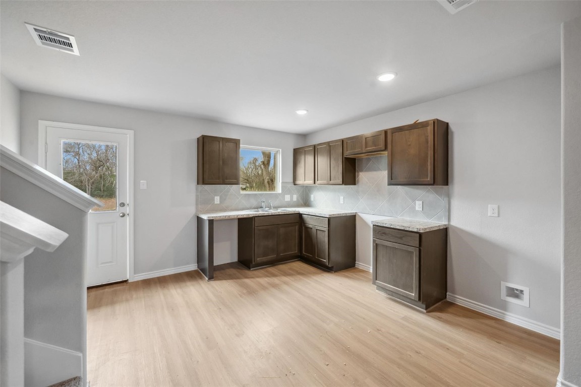 515 16th Street Hempstead, TX 77445 - Photo 12 of 23 a large kitchen with a sink and a stove top oven