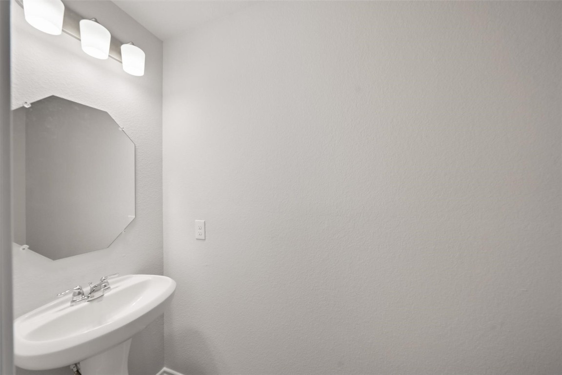 515 16th Street Hempstead, TX 77445 - Photo 13 of 23 a bathroom with a sink and a mirror