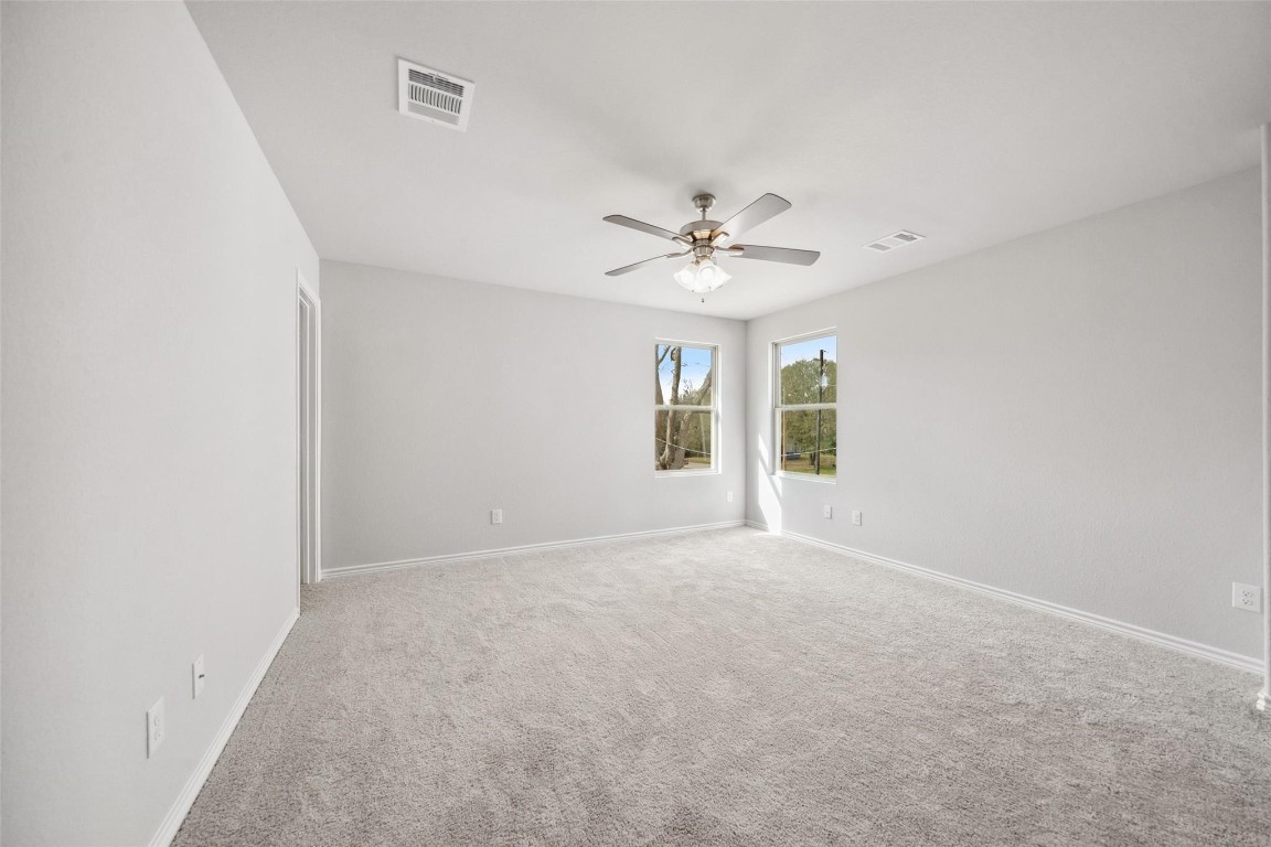 515 16th Street Hempstead, TX 77445 - Photo 14 of 23 an empty room with windows and fan