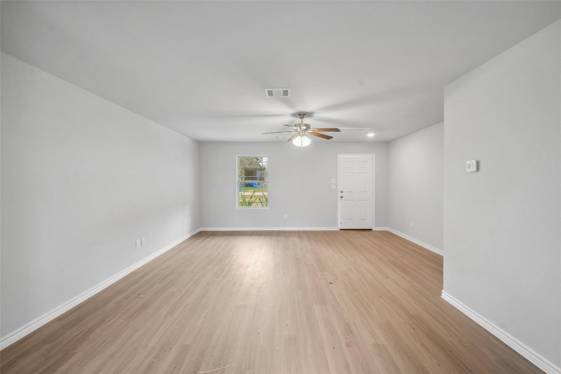 515 16th Street Hempstead, TX 77445 - Photo 4 of 23 an empty room with wooden floor and windows