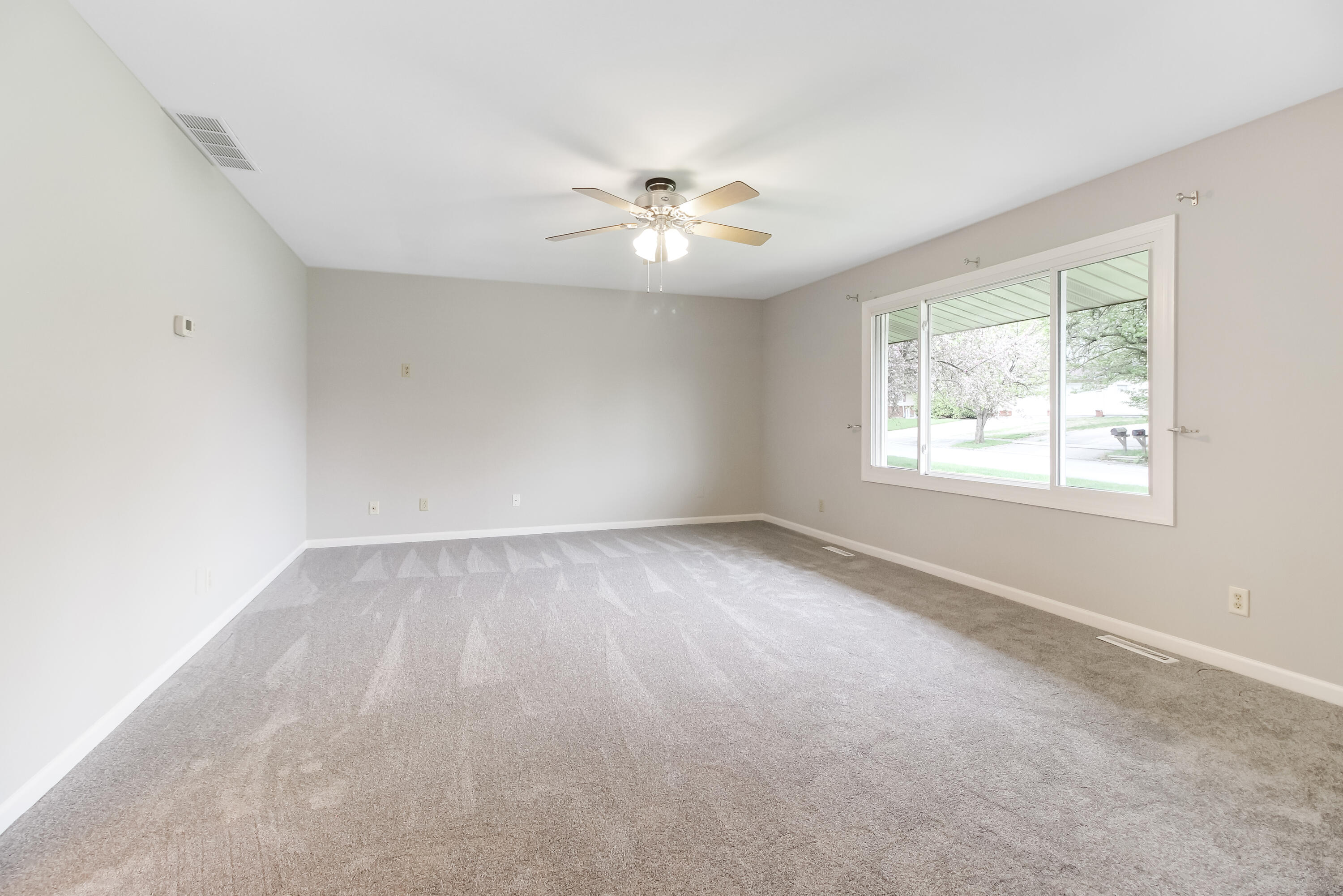 7348 West 83rd Place Crown Point, IN 46307 - Photo 5 of 14 an empty room with a window and a fan