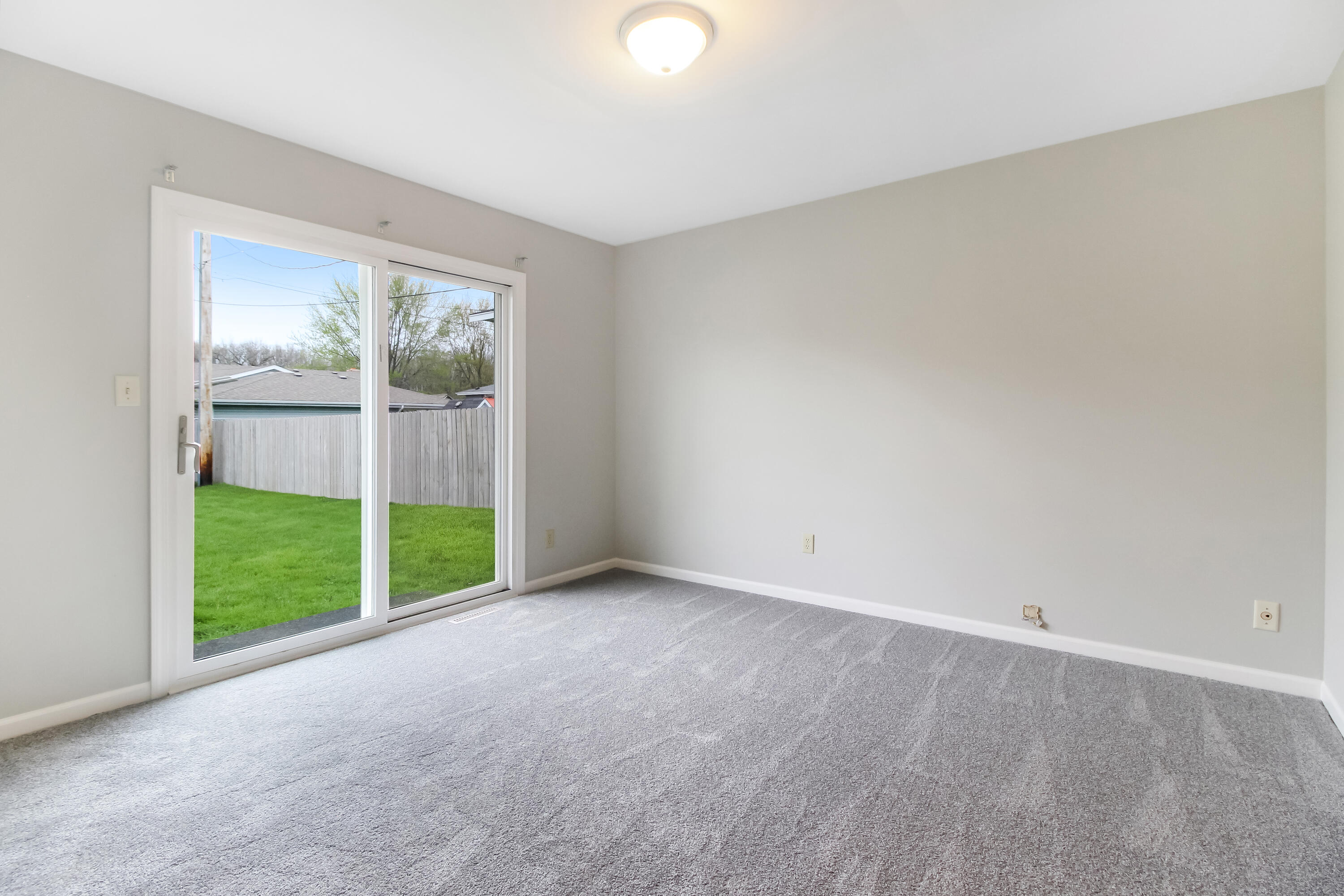 7348 West 83rd Place Crown Point, IN 46307 - Photo 6 of 14 a view of an empty room with wooden floor and a window
