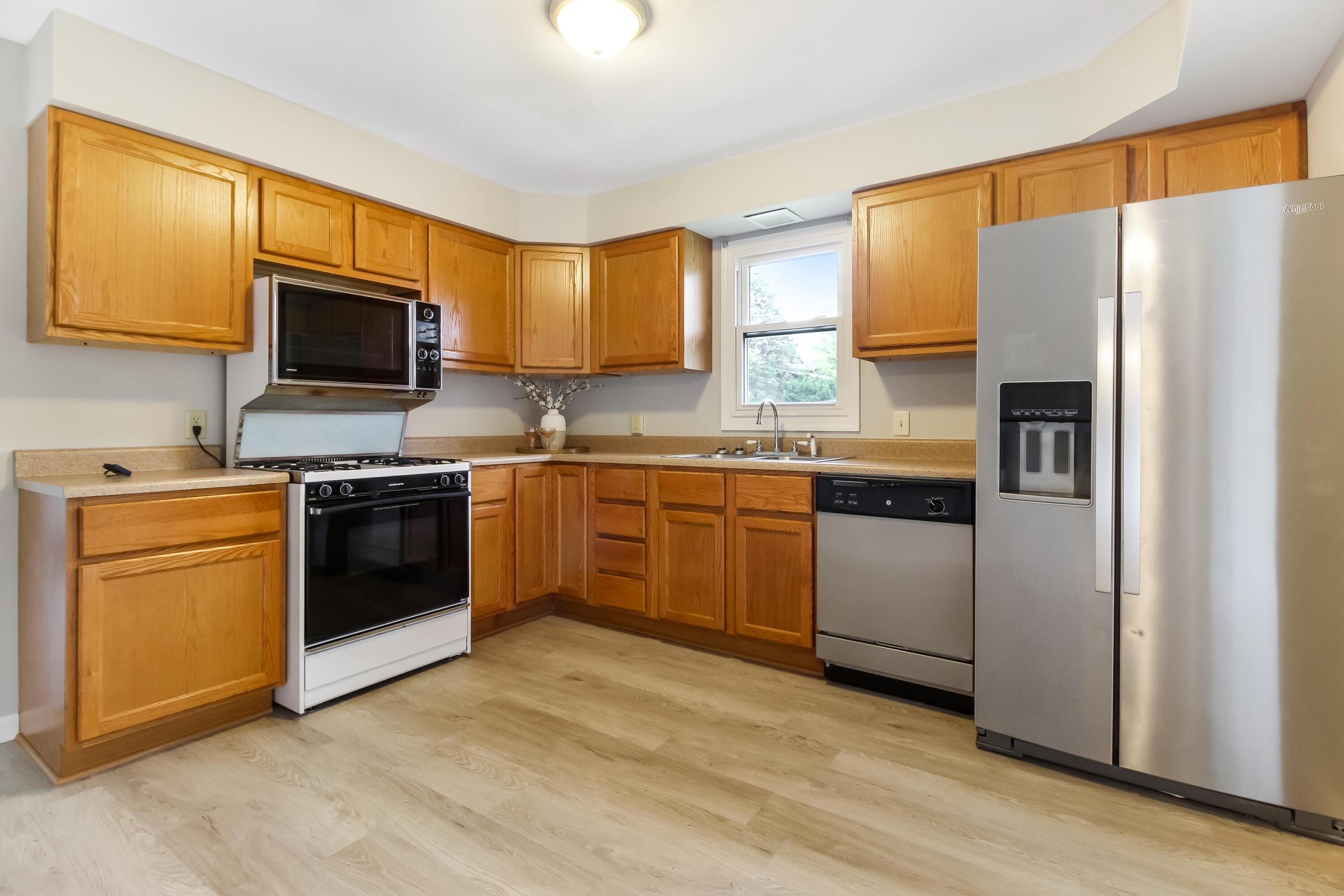 7348 West 83rd Place Crown Point, IN 46307 - Photo 10 of 14 a kitchen with a sink cabinets stainless steel appliances and a window