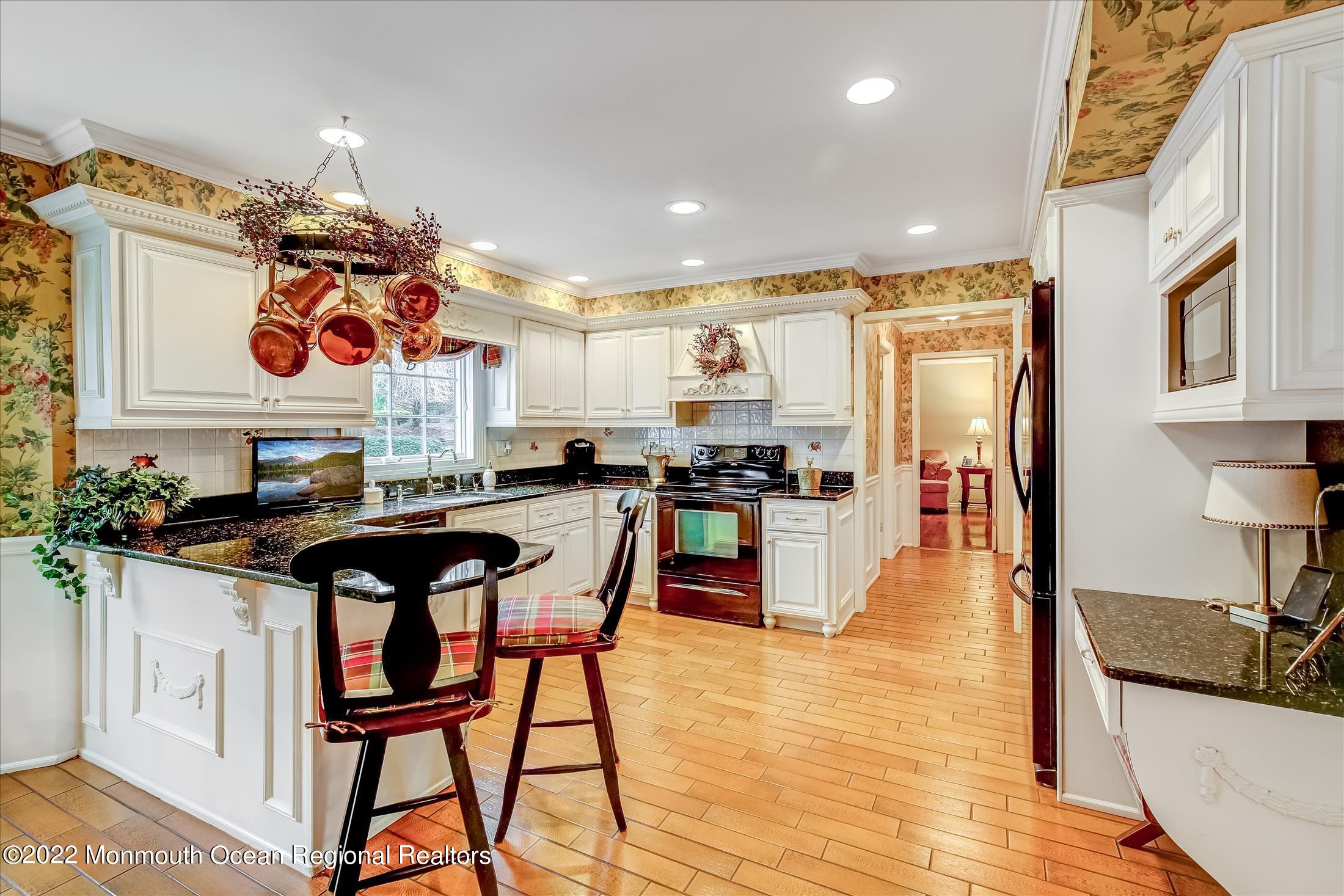 45 Ruby Drive Morganville, NJ 07751 - Photo 13 of 47 a kitchen with stainless steel appliances granite countertop a sink a stove and a refrigerator