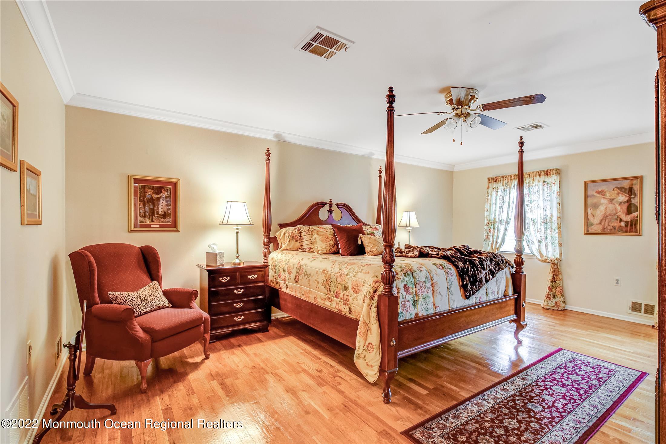45 Ruby Drive Morganville, NJ 07751 - Photo 27 of 47 a bedroom with a bed and wooden floor