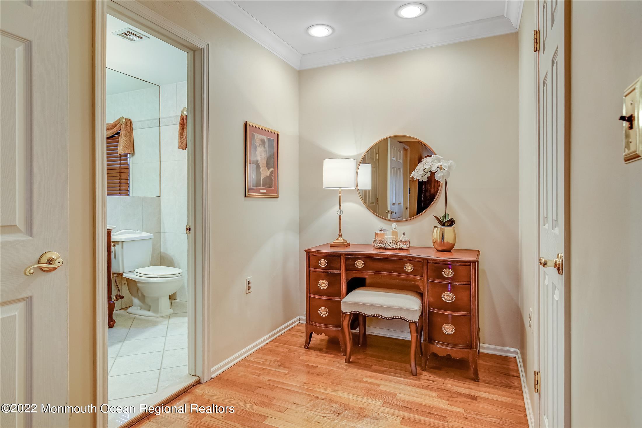 45 Ruby Drive Morganville, NJ 07751 - Photo 30 of 47 a view of a bathroom with a toilet a sink and a mirror
