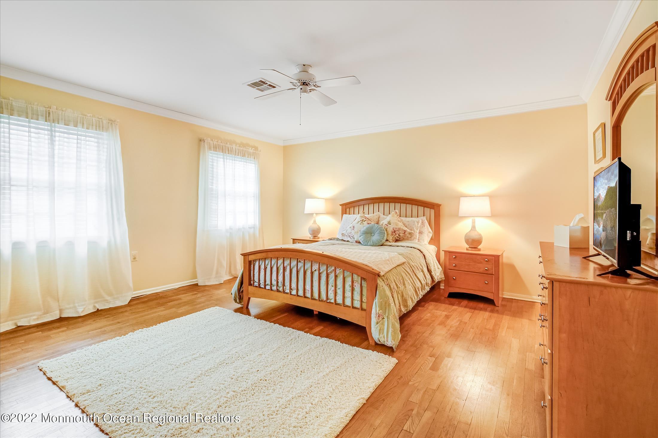 45 Ruby Drive Morganville, NJ 07751 - Photo 33 of 47 a bedroom with a bed and a chandelier