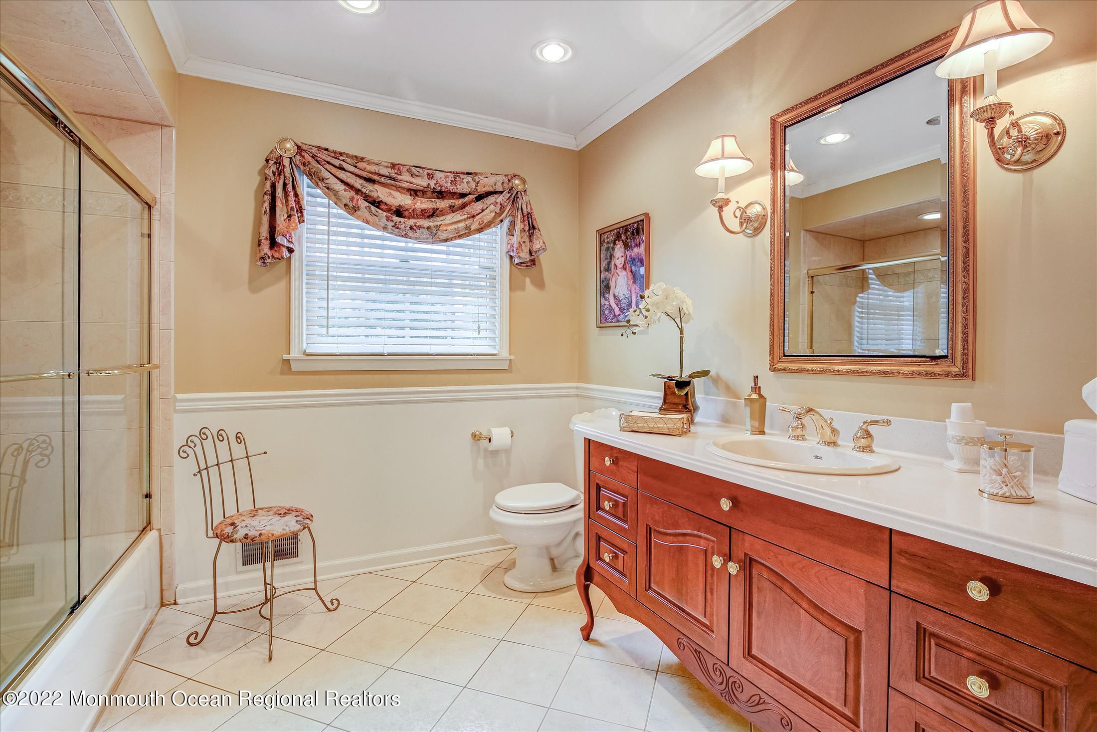 45 Ruby Drive Morganville, NJ 07751 - Photo 35 of 47 a bathroom with a double vanity sink a toilet and a mirror