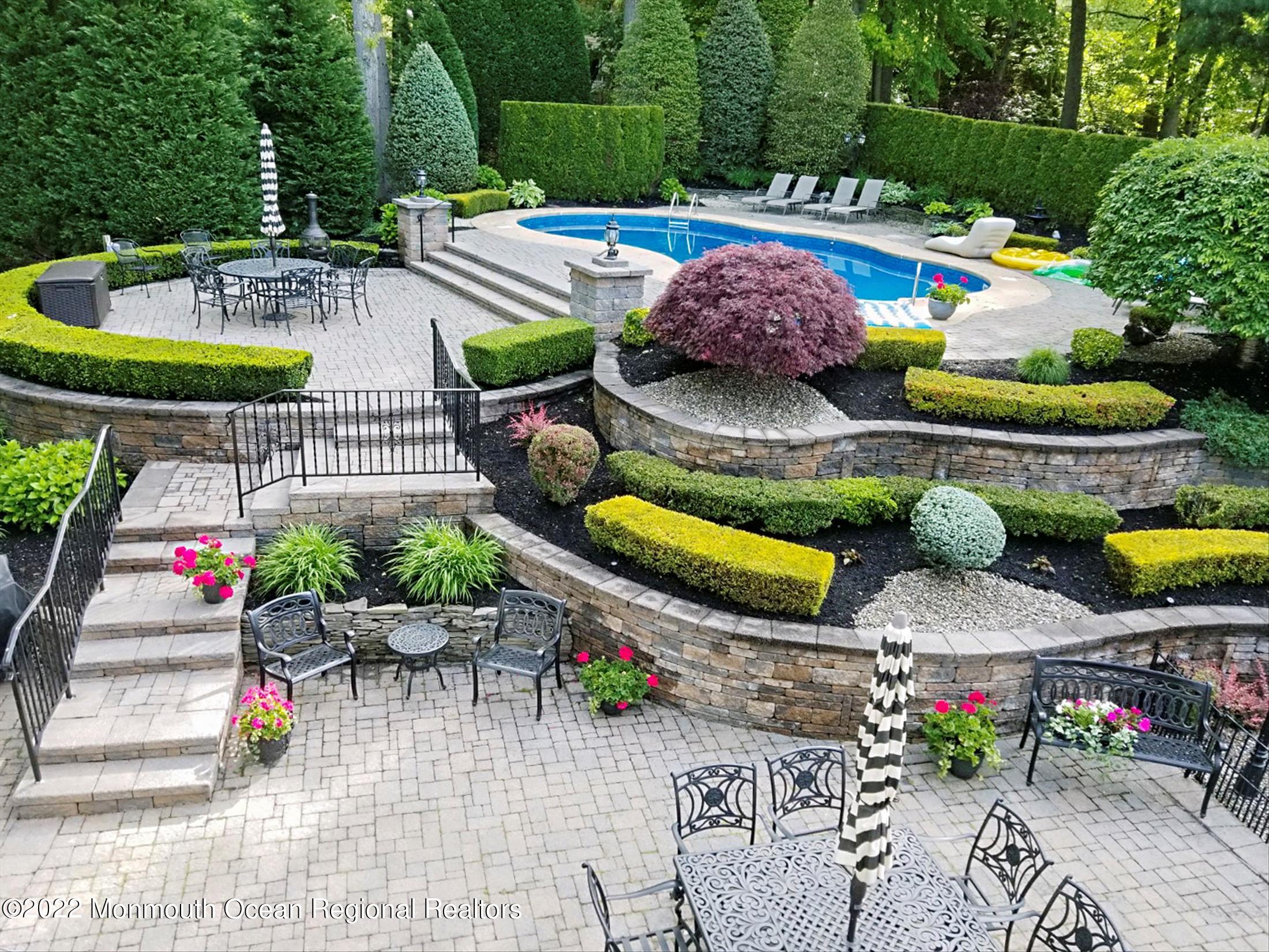 45 Ruby Drive Morganville, NJ 07751 - Photo 37 of 47 a roof deck with table and chairs potted plants and palm tree