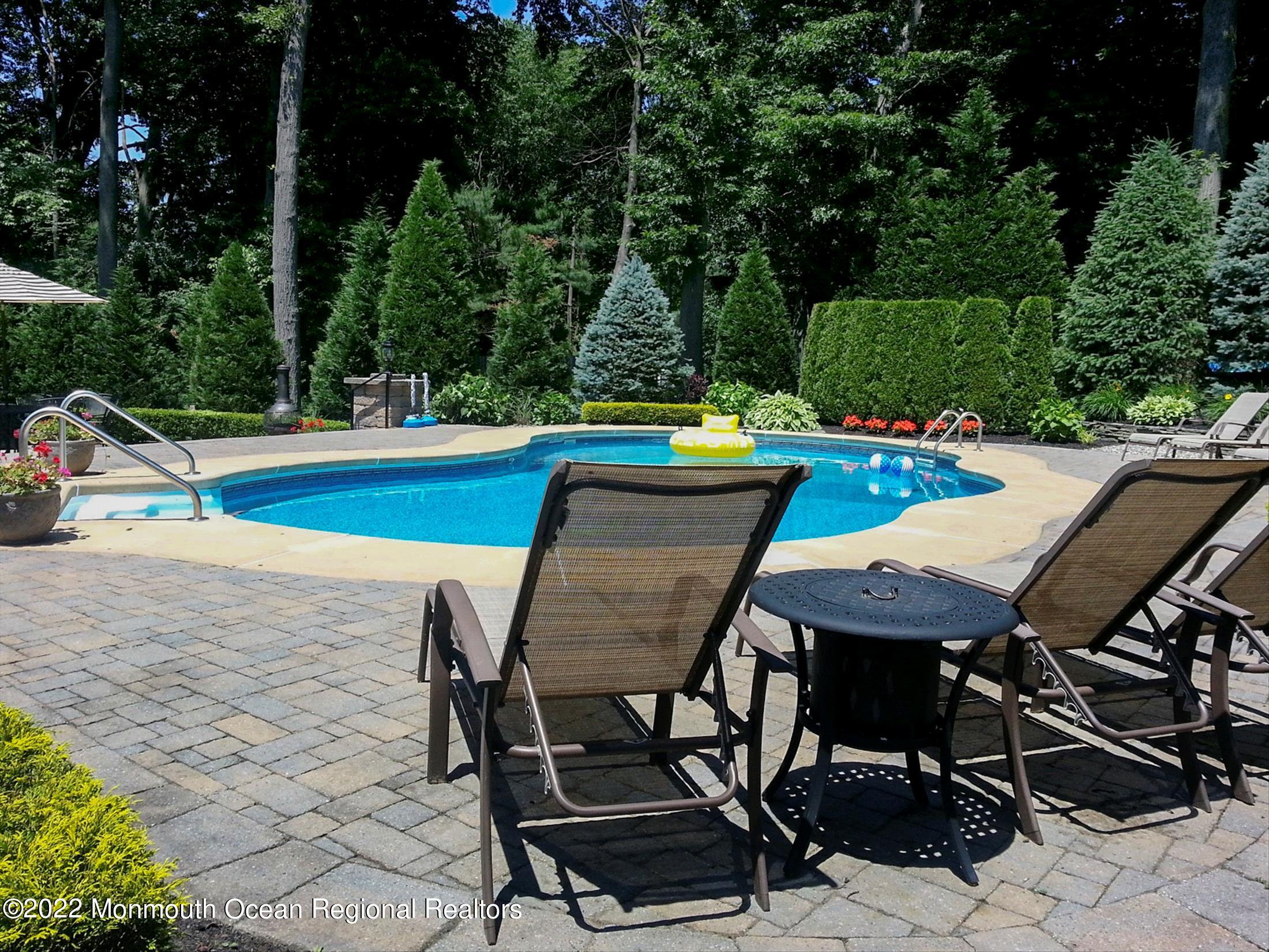 45 Ruby Drive Morganville, NJ 07751 - Photo 38 of 47 a view of a chairs and table on the terrace