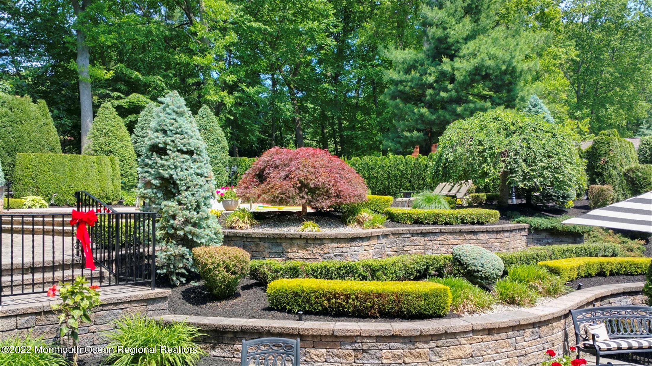 45 Ruby Drive Morganville, NJ 07751 - Photo 43 of 47 a view of a backyard with plants and outdoor seating