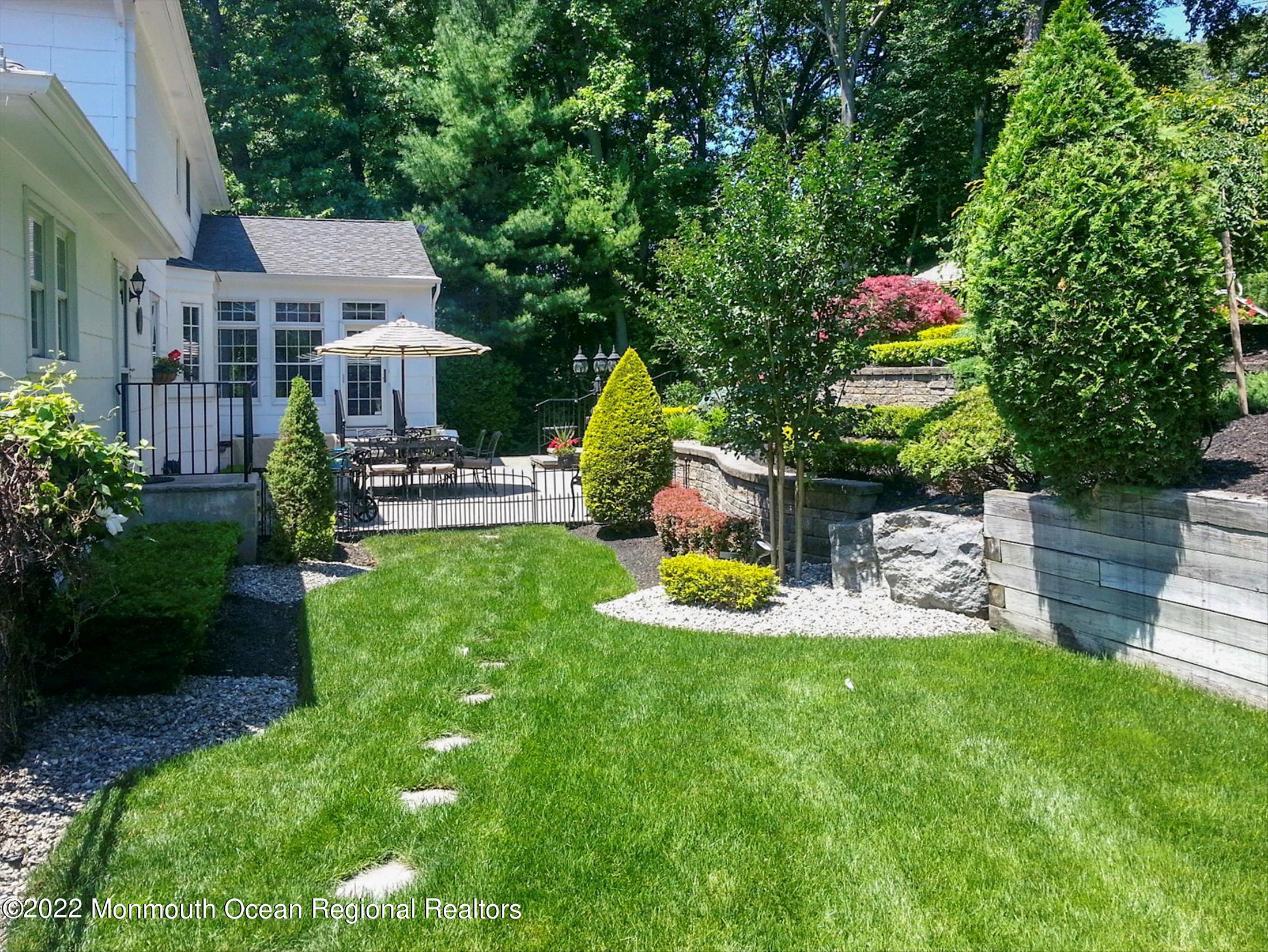 45 Ruby Drive Morganville, NJ 07751 - Photo 44 of 47 a view of a chair and table in backyard of the house