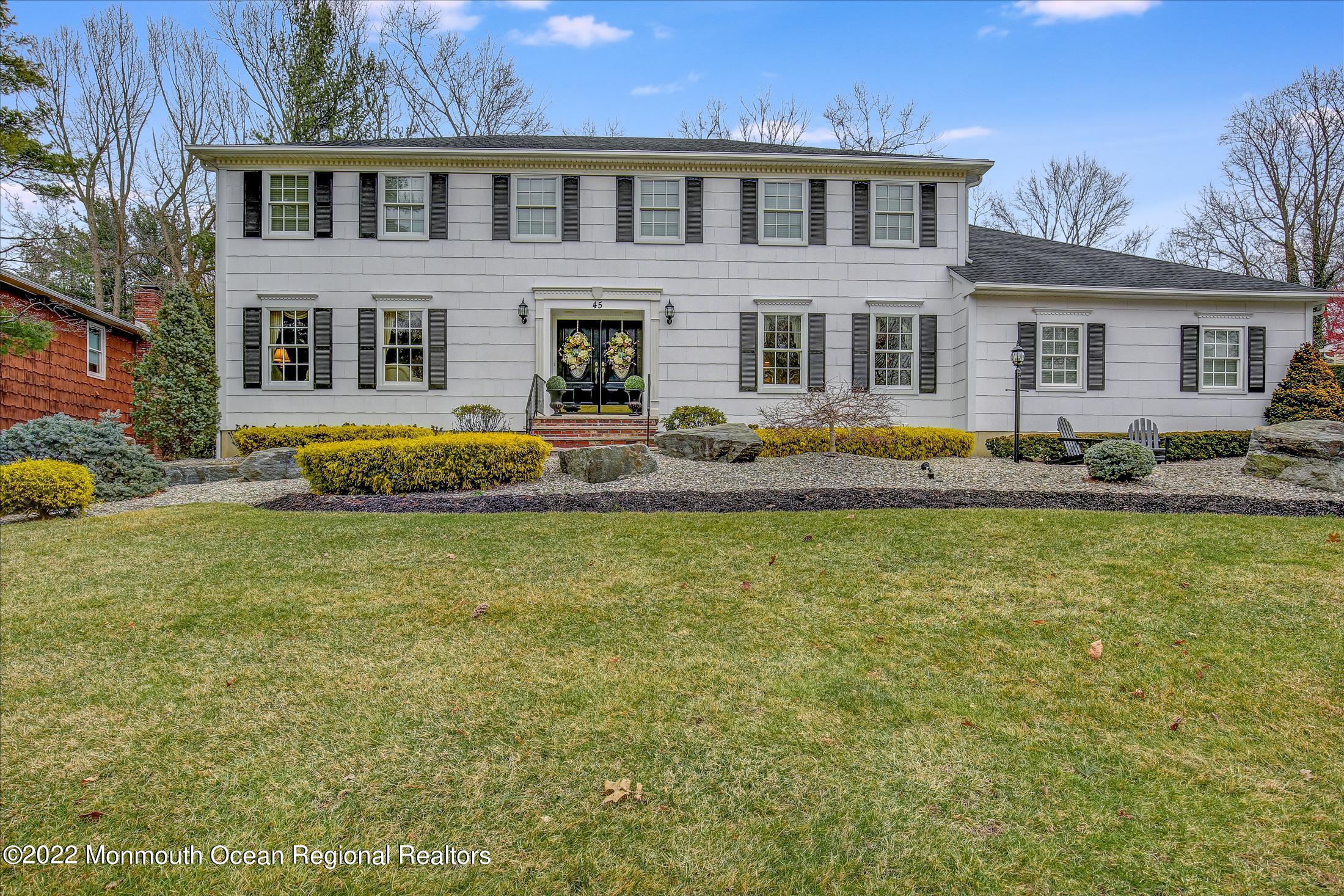 45 Ruby Drive Morganville, NJ 07751 - Photo 5 of 47 a front view of house with outdoor seating yard and barbeque oven