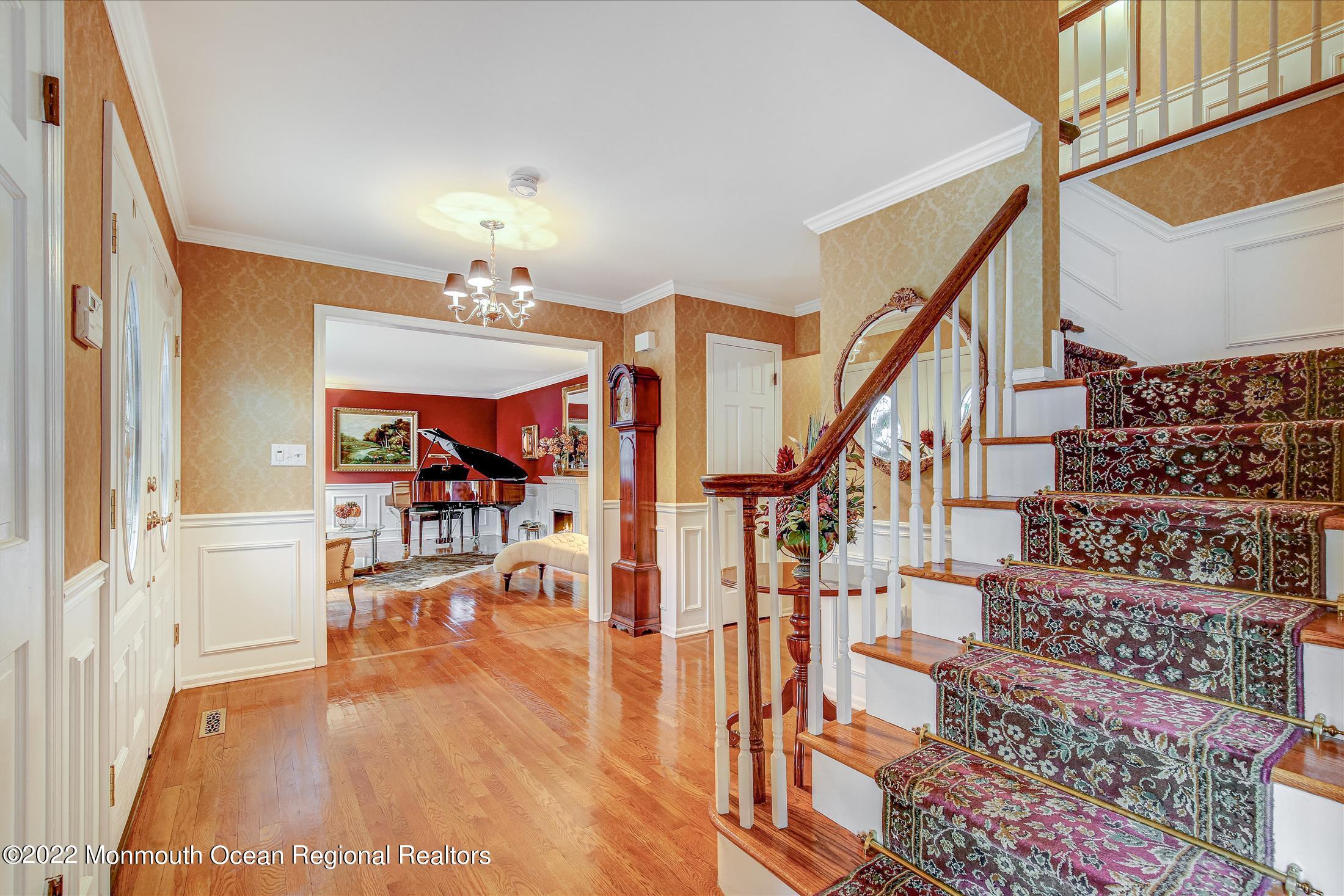 45 Ruby Drive Morganville, NJ 07751 - Photo 8 of 47 a view of entryway dining room and hall with wooden floor