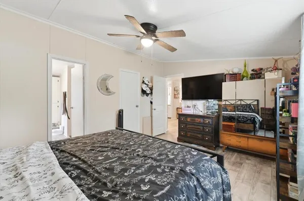 a bedroom with a bed and a chandelier