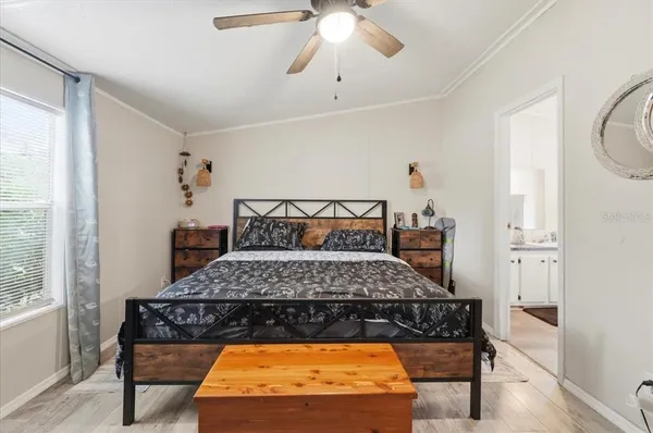 a bedroom with a bed and a chandelier