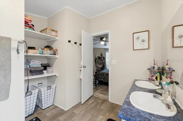 a bedroom with a bed and a refrigerator