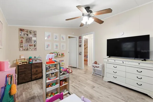 a living room with furniture a flat screen tv and a large window