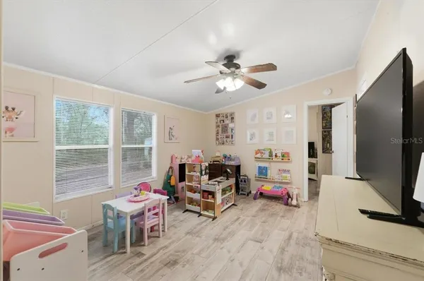 a view of a workspace with furniture and a flat screen tv