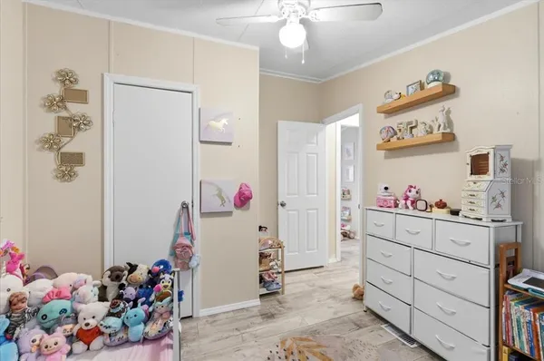 a bedroom with furniture and a baby crib