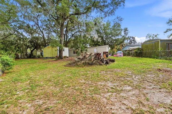 a view of a house with a backyard