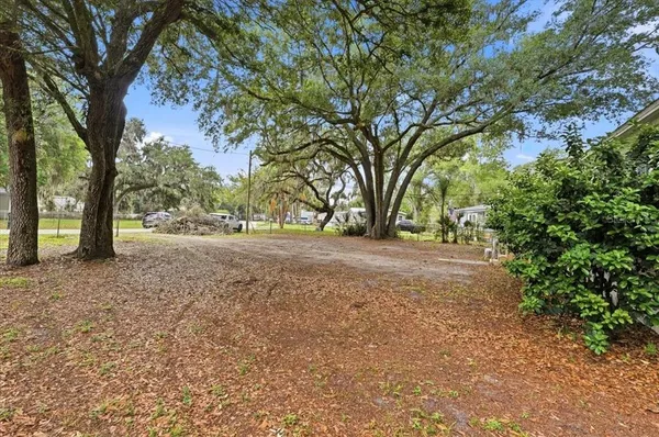 a backyard of a house with table and chairs