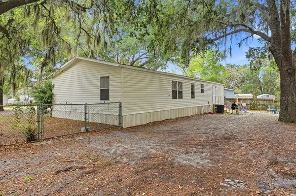 an aerial view of residential houses with outdoor and green space
