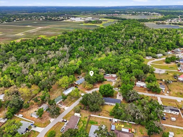 an aerial view of a house with a yard and lake view