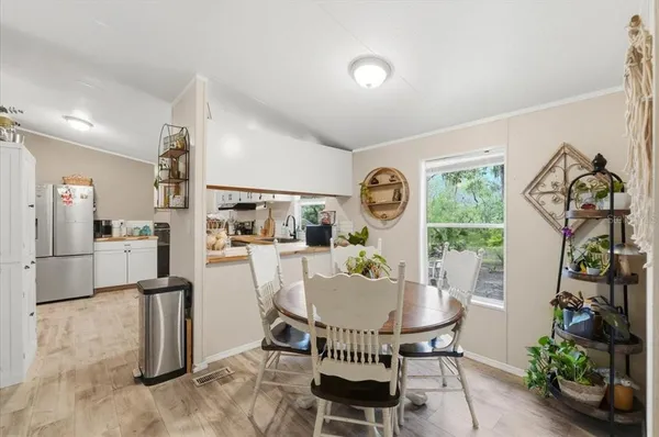 a dining room with furniture and window