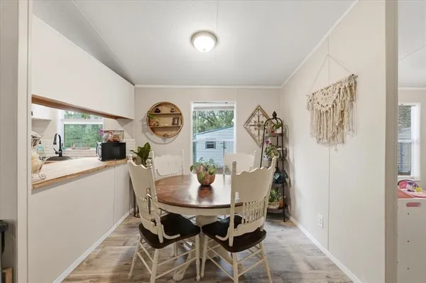 a view of a dining room with furniture and a large window