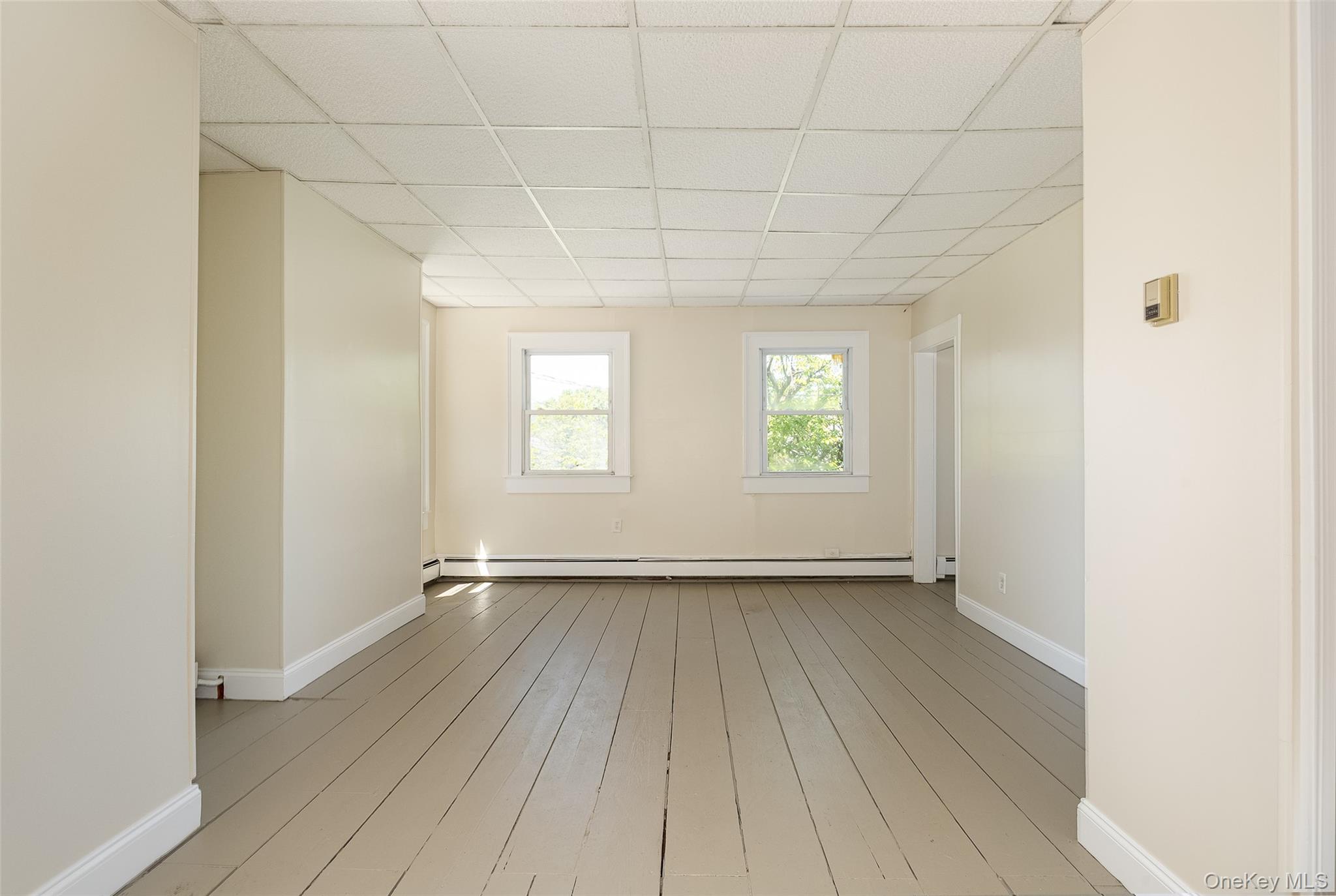29 Delano Street, Unit 2 Poughkeepsie, NY 12601 - Photo 6 of 16 an empty room with wooden floor and windows