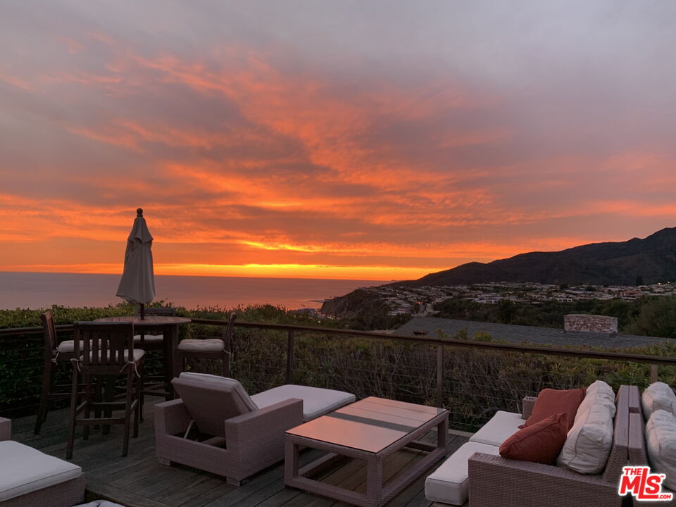 245 Tranquillo Road Pacific Palisades, CA 90272 - Photo 1 of 45 a view of a roof deck with couches and sky view