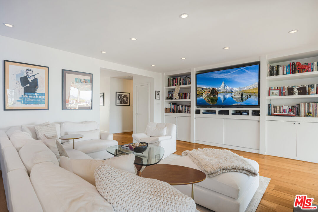 245 Tranquillo Road Pacific Palisades, CA 90272 - Photo 12 of 45 a living room with furniture kitchen view and a wooden floor