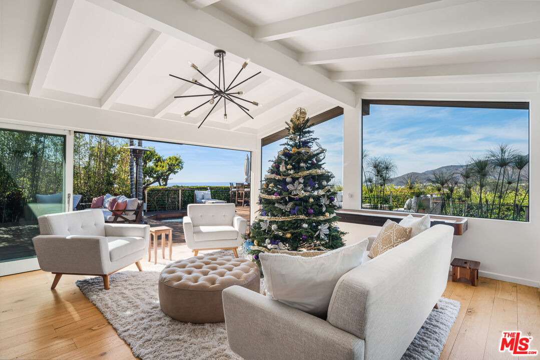 245 Tranquillo Road Pacific Palisades, CA 90272 - Photo 16 of 45 a living room with furniture and a large window