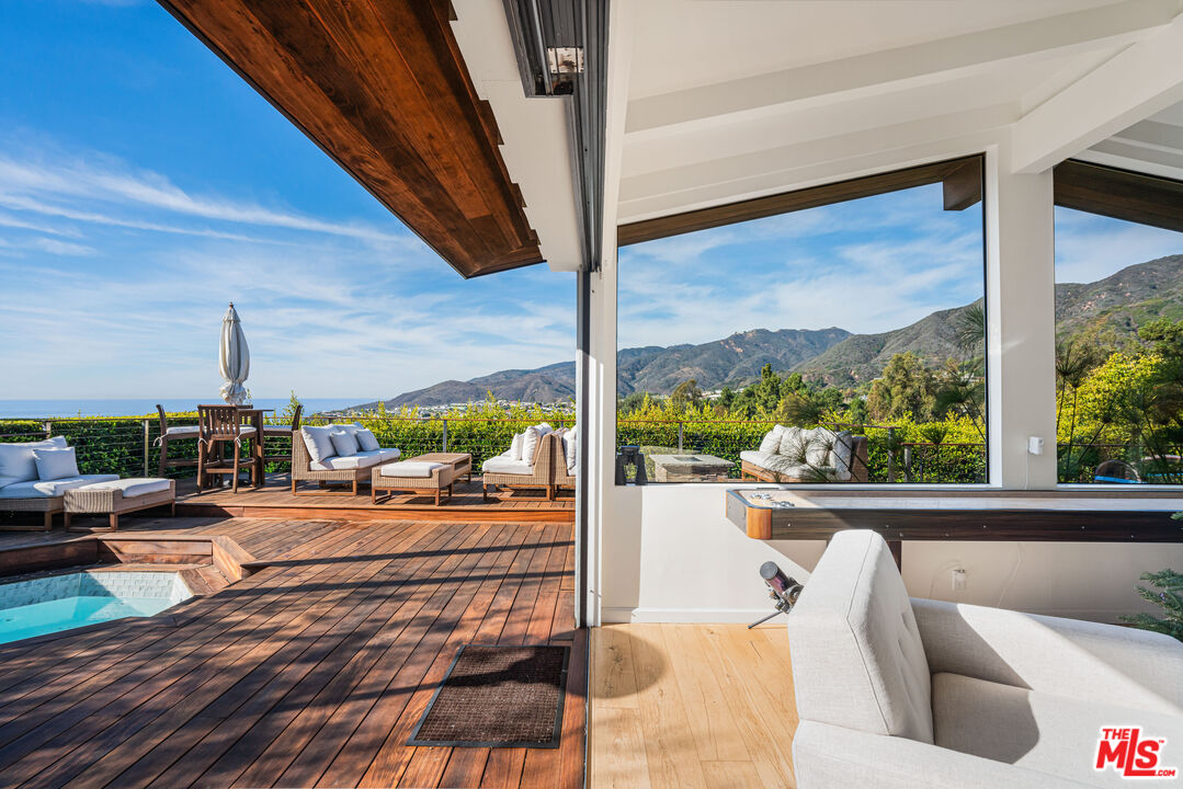 245 Tranquillo Road Pacific Palisades, CA 90272 - Photo 17 of 45 a view of living room with furniture and floor to ceiling window