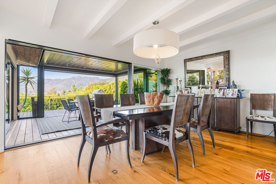 245 Tranquillo Road Pacific Palisades, CA 90272 - Photo 18 of 45 a view of a dining room with furniture window and wooden floor