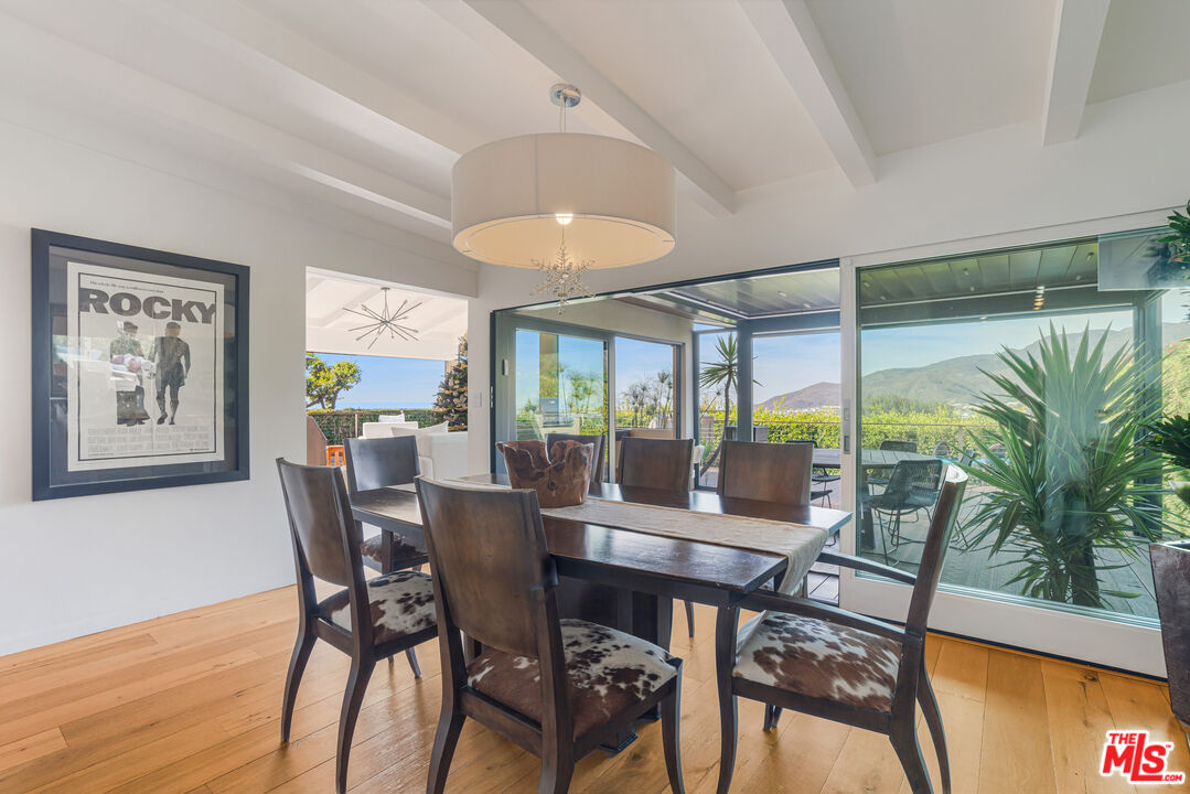 245 Tranquillo Road Pacific Palisades, CA 90272 - Photo 19 of 45 a view of a dining room with furniture window and wooden floor